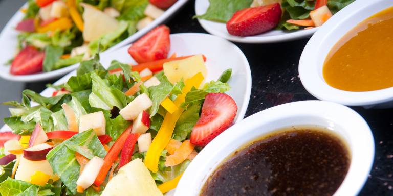 assorted fruit and vegetable salads with oil and dressing