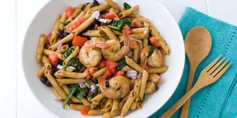 a bowl of seasoned penne and shrimp salad