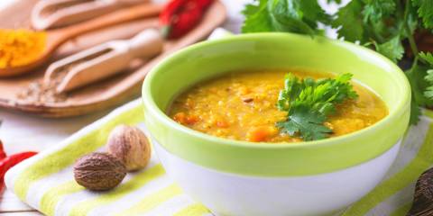 A steaming bowl of red lentil Dal Masoor