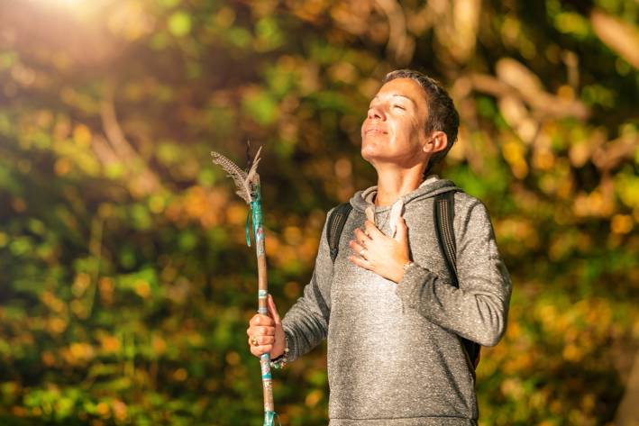 Mindful Change in Autumn a spiritual woman enjoying a peacful moment while on an autumn hike
