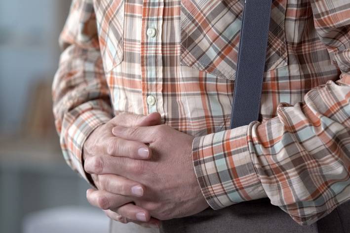 Hiatal Hernia a man holding his gut in pain from a hernia