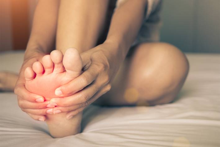 Understanding Common Foot Problems A woman massaging pain in his foot
