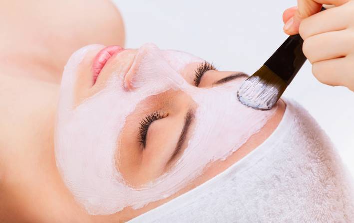 Face mask being applied to a person's face. 