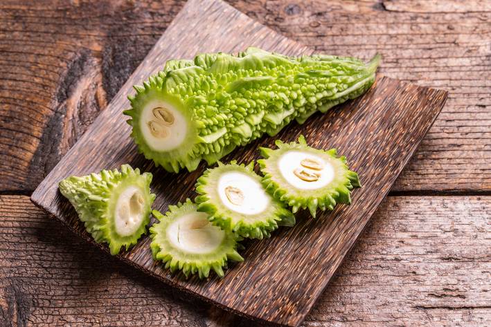 Supplements for Better Blood Sugar a bitter gourd on a cutting board