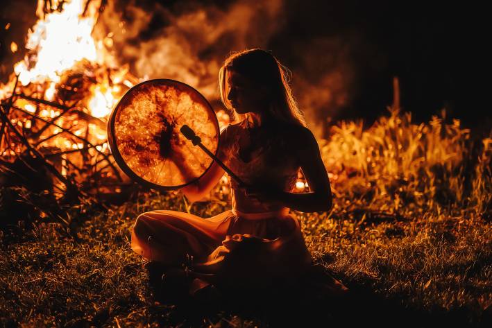 Earth Medicines: Fire a shamanic woman beating a drum by the fire