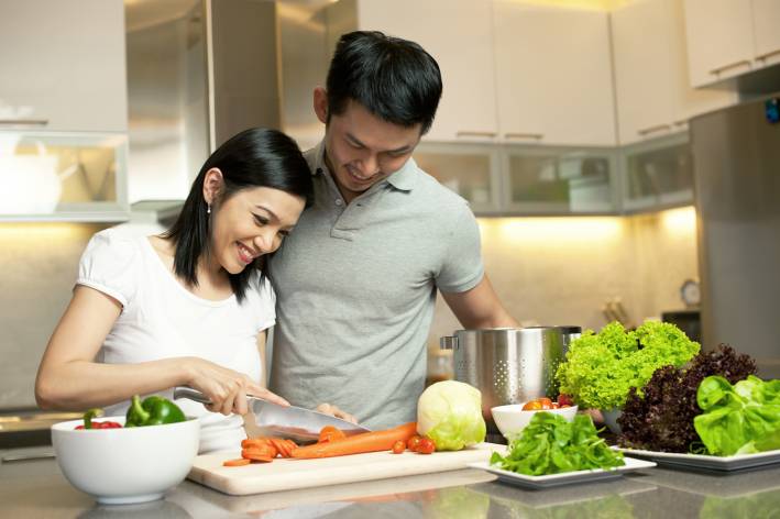 Partner Benefits A couple preparing dinner together.