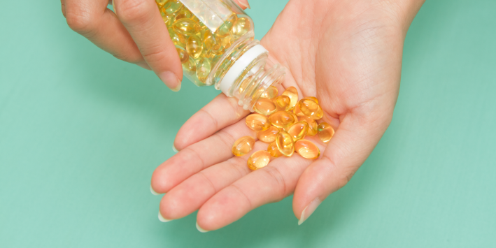 Omega-3 Nutrition: The Single Most Important Part of Your Pregnancy Woman with Omega 3 pills