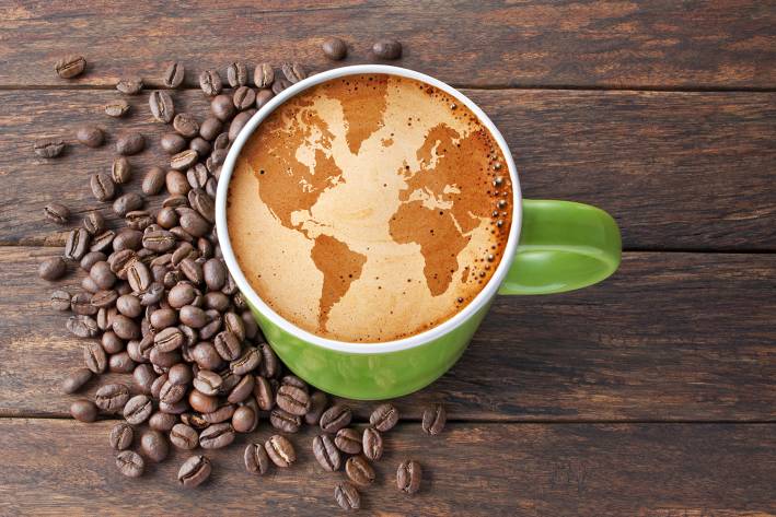 Fair Trade and Coffee coffee beans, and a latte with the world drawn on it