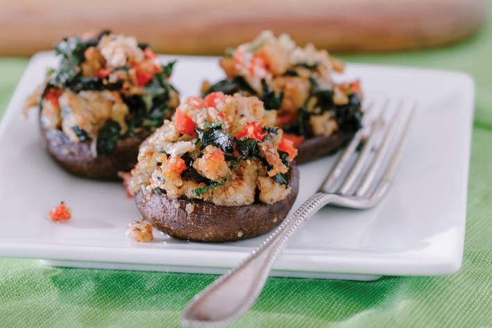 Stuffed Crimini Mushrooms with Kale and Sausage Stuffed crimini mushrooms on a white square plate with fork.