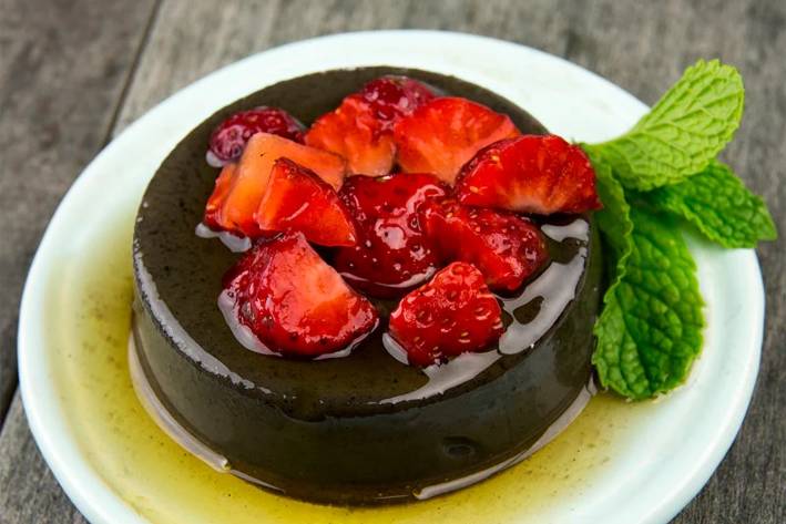 Black Sesame Flan a delicious plate of flan with fruit on top