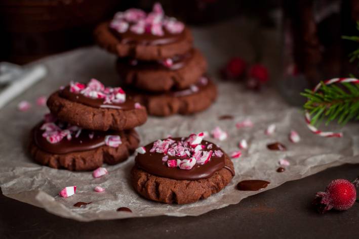 Chocolate-Peppermint Cookies a plate of chocolate cookies with crushed candy canes