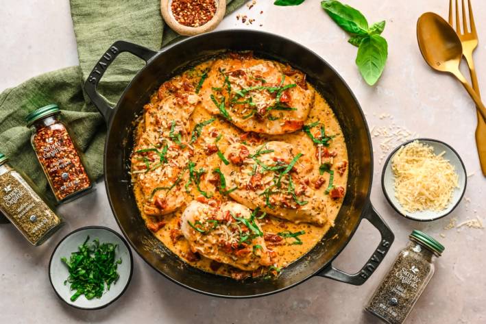 Marry Me Chicken a skillet of chicken and sauce with herbs
