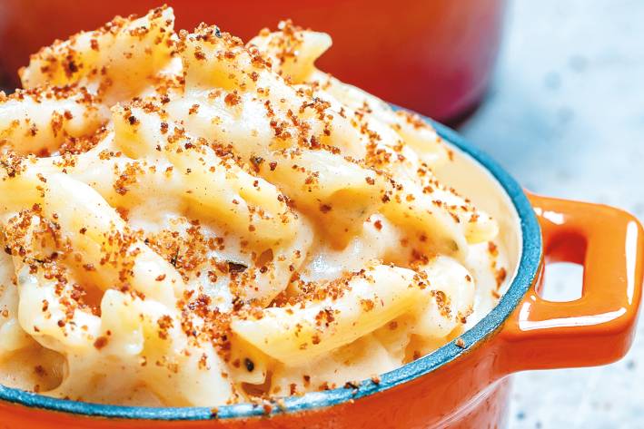 Smoky Mac & Cheese Smoky mac and cheese served in an orange mini dutch oven.