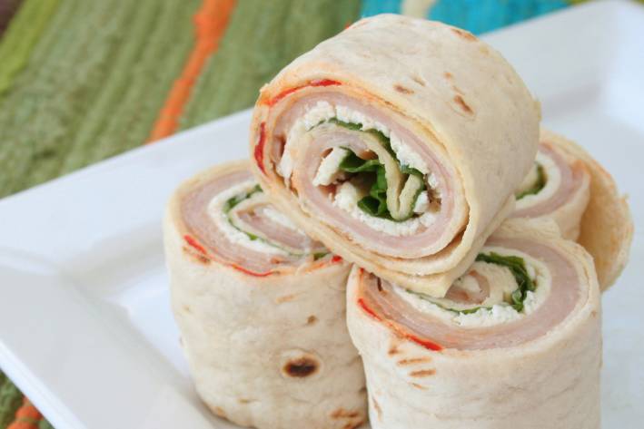 Turkey Wraps with Mango and Curried Mayonnaise a turkey wrap sliced into four pieces