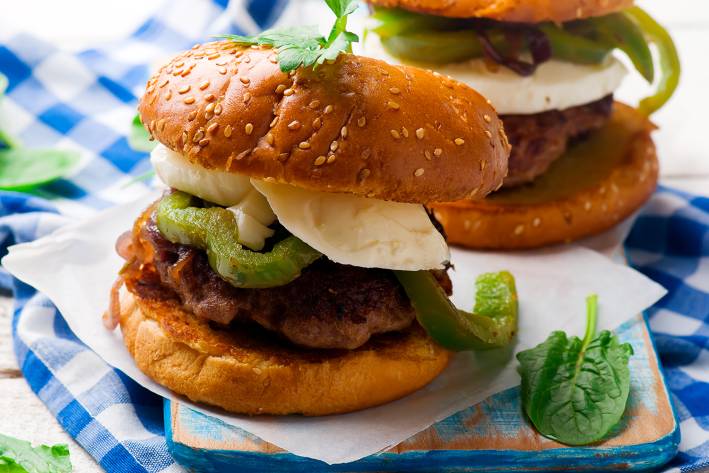 Chicken Sausage and Bell Pepper Sliders A plate of chicken sausage sliders with bell peppers and fresh basil