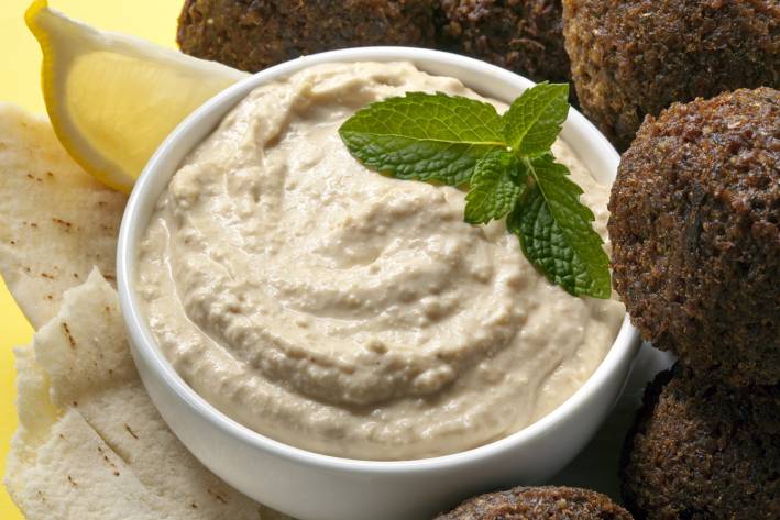 Homemade Lemon Hummus a bowl of creamy hummus and some falafel