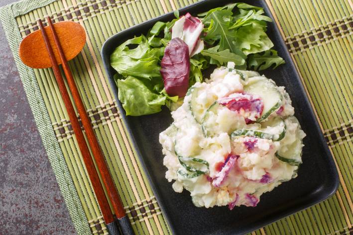 Japanese Potato Salad chopsticks and a bowl of mashed potatoes and vegetables