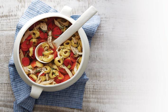 Chicken Tortellini Soup Chicken tortellini soup in a white soup crock.