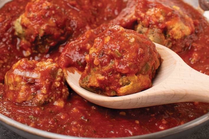 Eggplant Meatballs with Spicy Marinara an eggplant meatball covered in red sauce