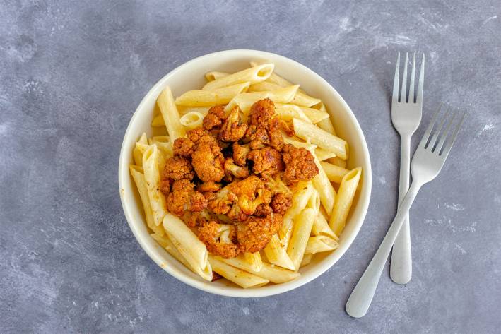 Penne with Spice-Roasted Cauliflower a bowl of penne with spicy roasted cauliflower on top