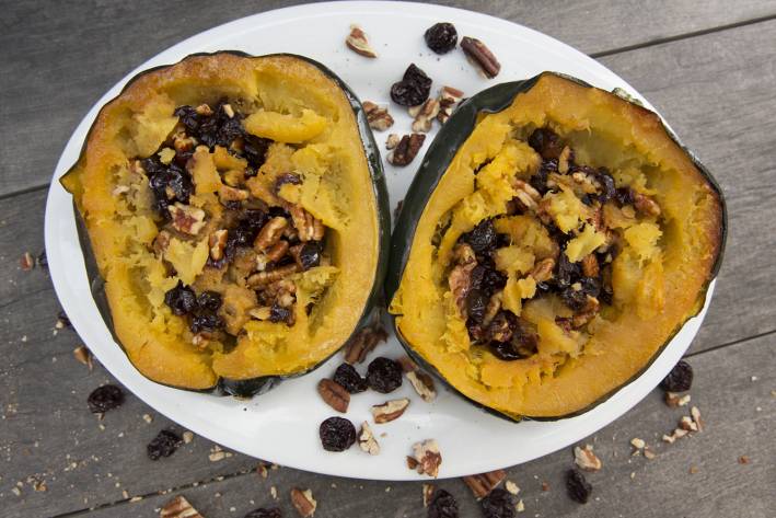 Stuffed Acorn Squash A plate of acorn squash stuffed with berries and pecans