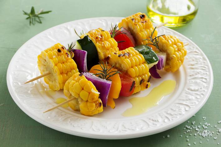 Vegetable Kebabs with Smoked Paprika a plate of grilled vegetables on skewers with oil and seasoning