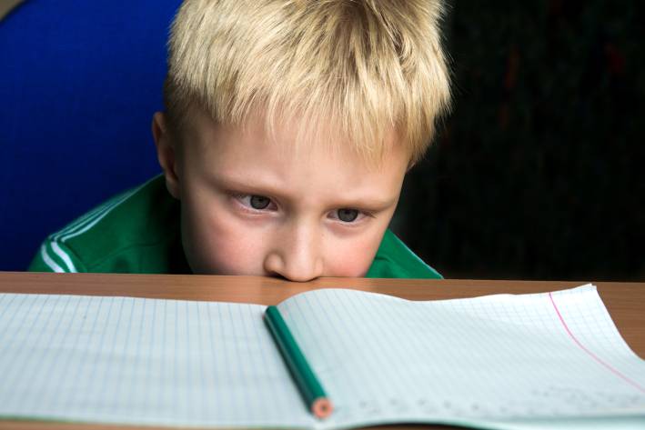 Natural Help for ADHD A child staring helplessly at his blank schoolwork