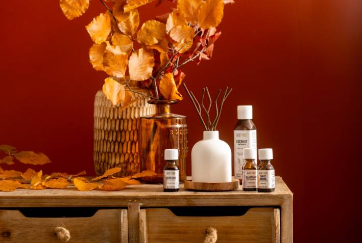 Fall Leaves Reed Diffuser wooden dresser with vase full of fall branches, essential oils and reed diffuser