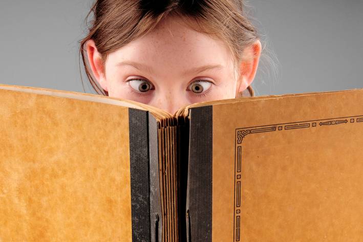Children's Eye Health a cross-eyed child reading a book