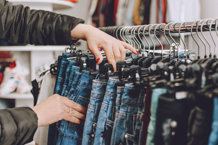 How Clothing Choices Affect the Environment a woman shopping for jeans
