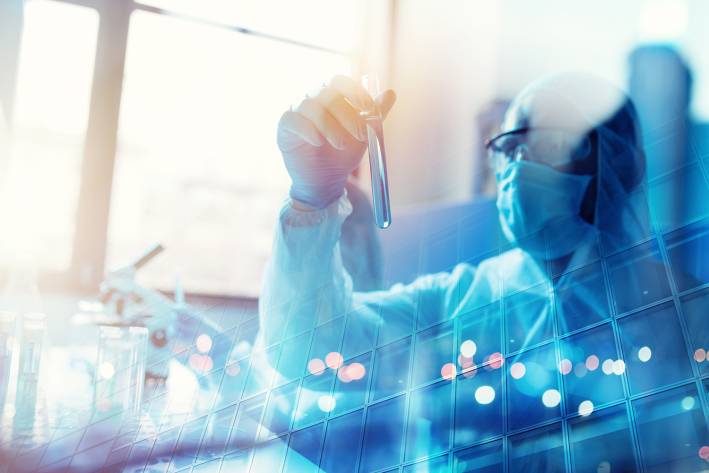 Experts Urge Caution with Oleander Extract Doctor studying a vial during covid-19 coronavirus research.