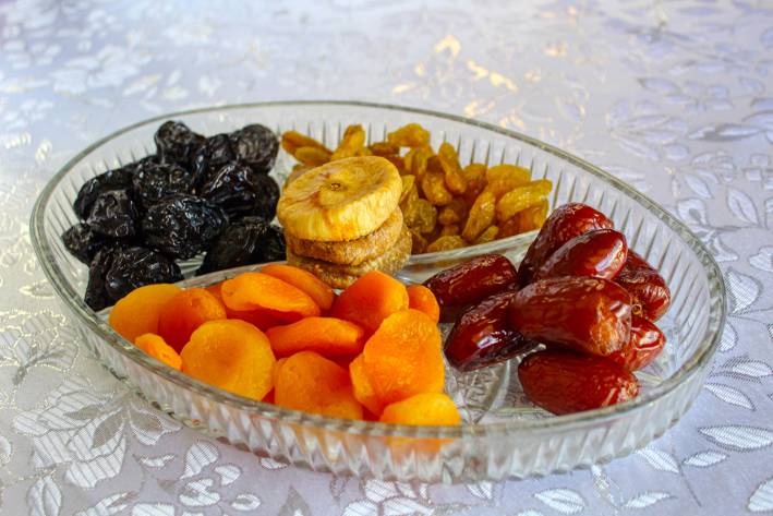 Dates vs. Prunes a glass tray of dried fruit