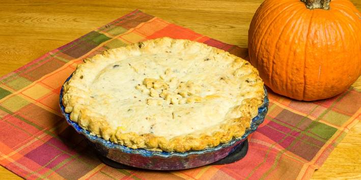 Easy Halloween Dinners a turkey pot pie next to a pumpkin