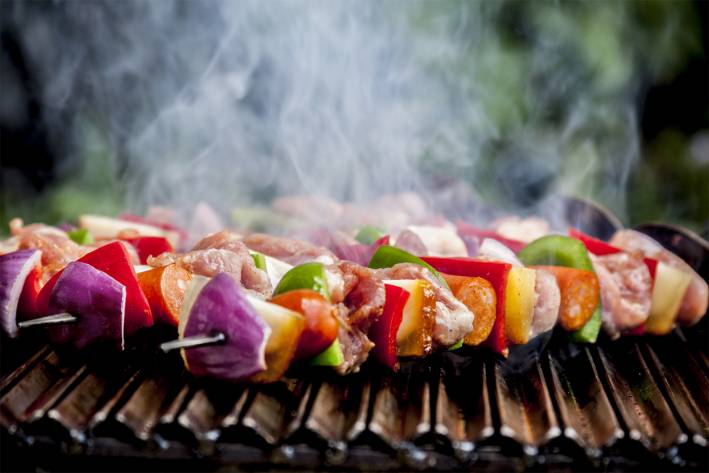 Summer Grilling & Chilling shish kebabs with vegetables, fruit, and meat, smoking and steaming